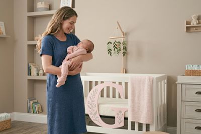 a woman holding a baby in her arms