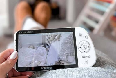 A mom using a baby monitor.