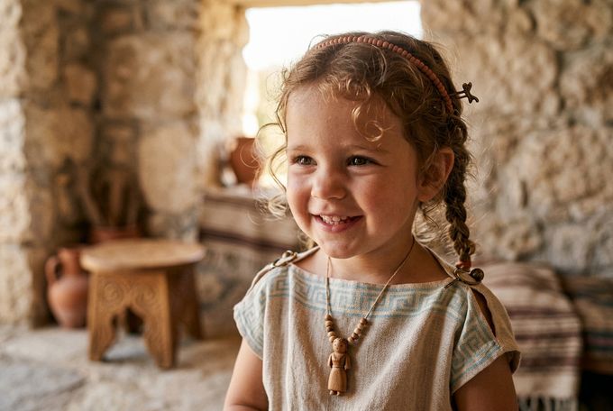 a little girl that is smiling for the camera