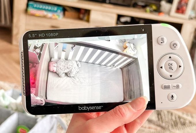 a person holding a video game controller in their hand