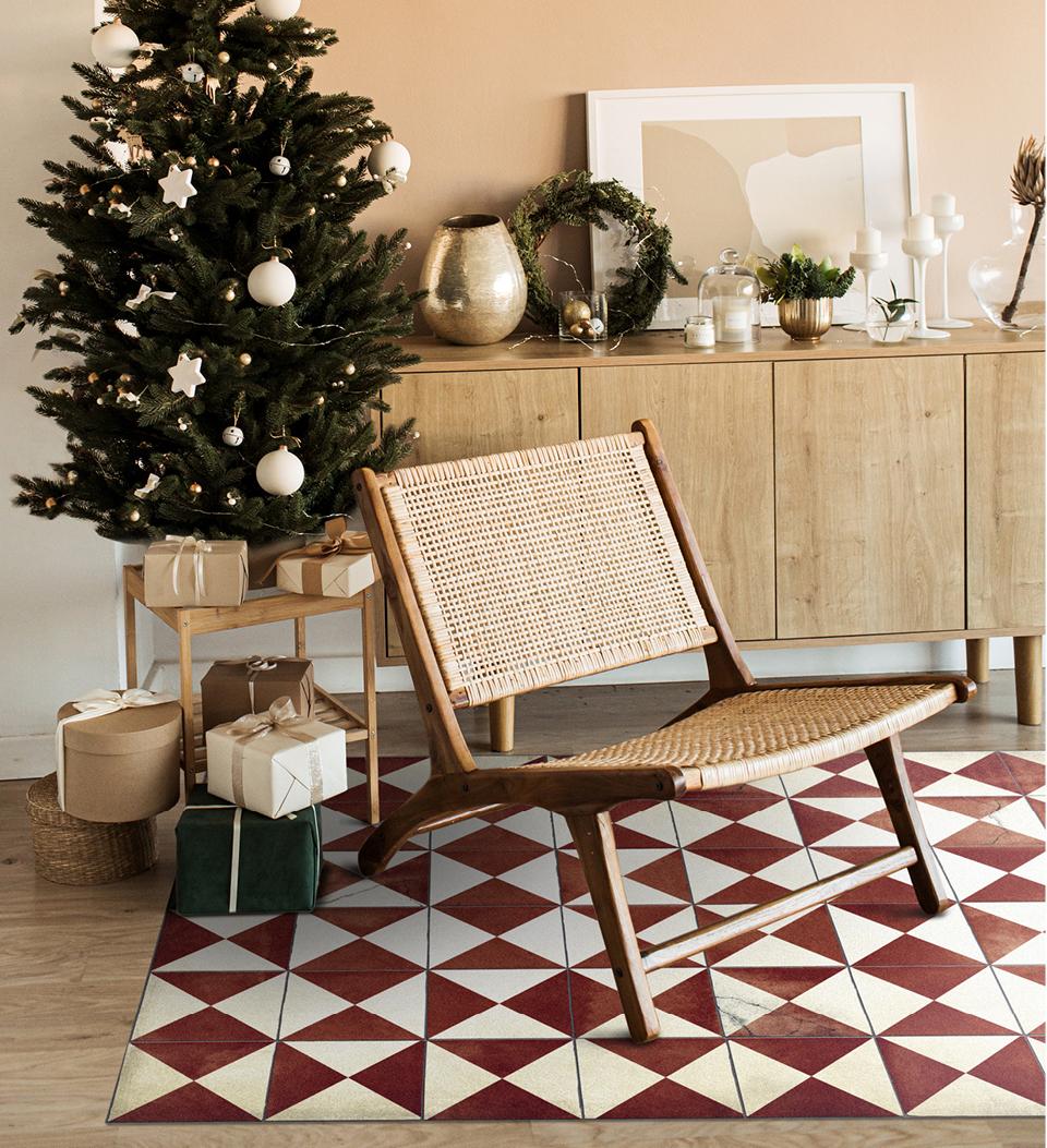Red and white triangle-patterned rug under a living room chair and a Christmas tree