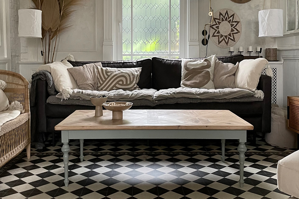 Monochrome checkered rug in a living room with furniture in neutral tones