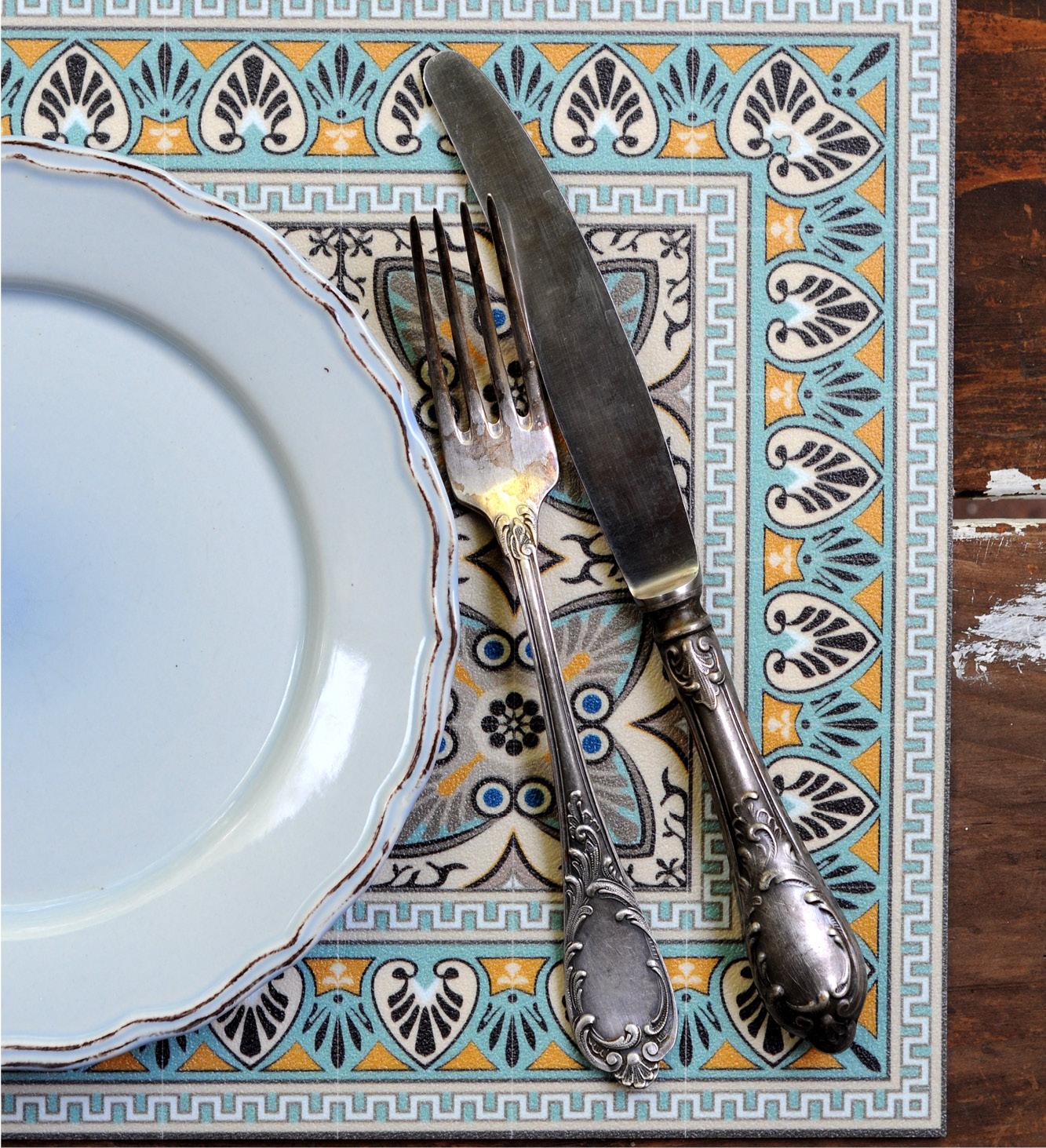 A table runner with a colorful African style print placed under a dinner set 