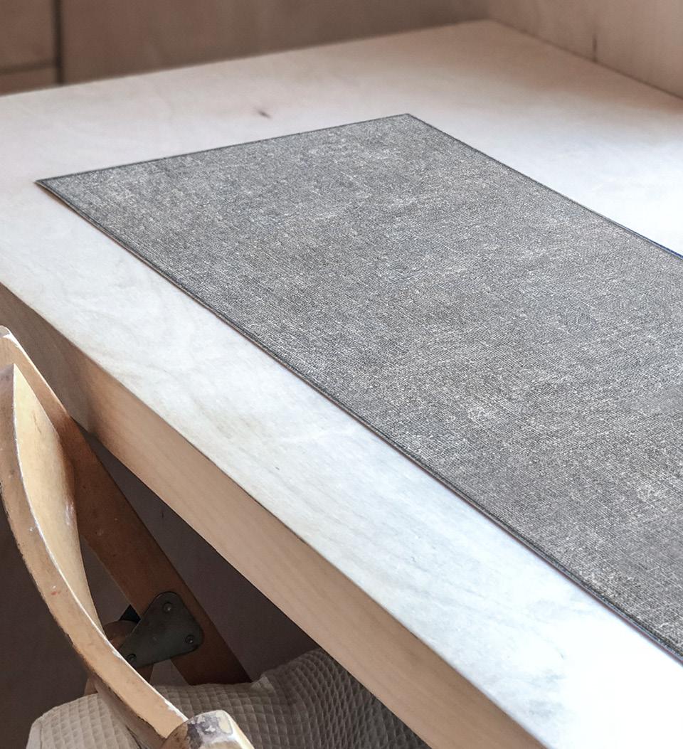 A gray linen table runner on a light wooden table