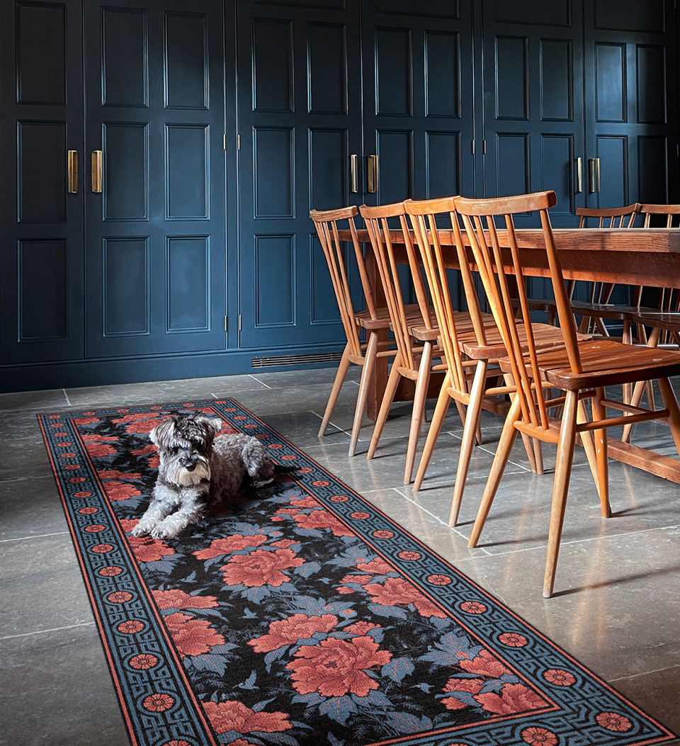 Grean and red Floral patterned rug with a dog sleeping on top in a dining room 