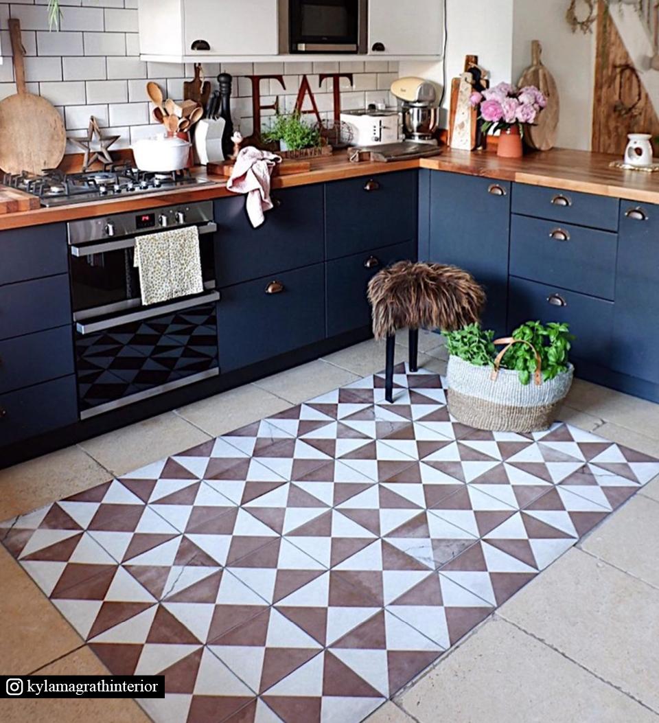 Open-concept kitchen with a retro red and white tile kitchen rug