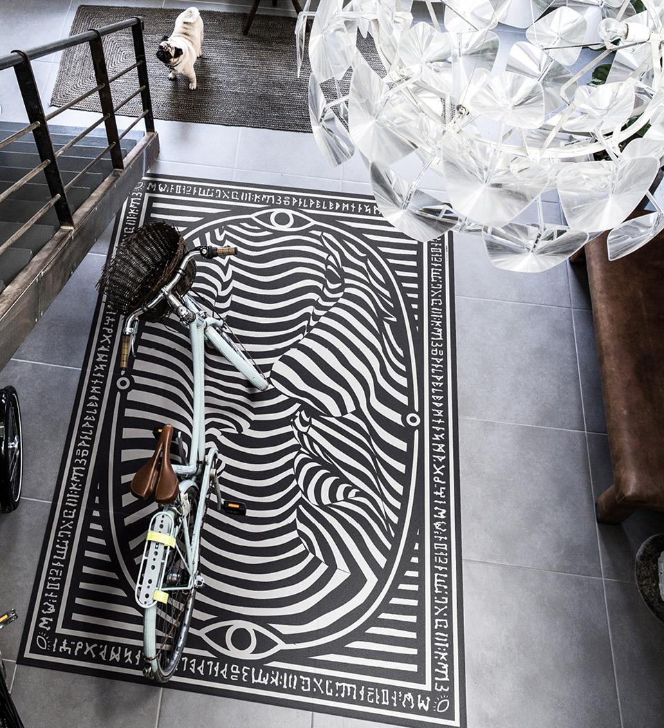 A zebra-patterned rug on an entryway floor seen from above