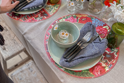 Mediterranean placemats folded aesthetically on decorative table settings