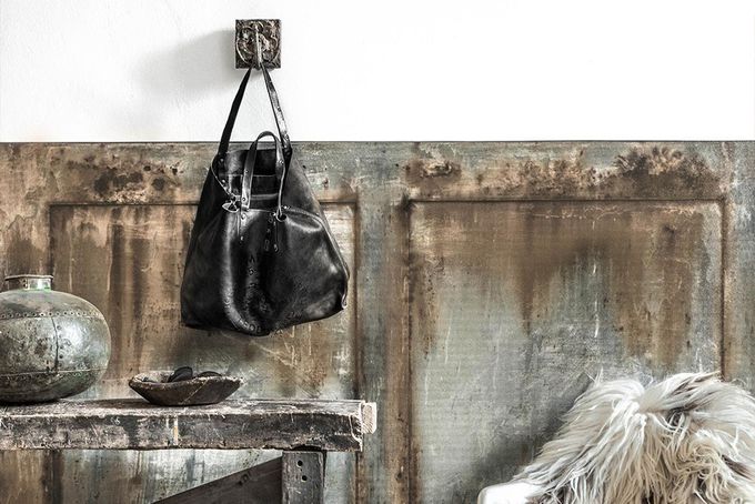Rustic wall art behind a side table