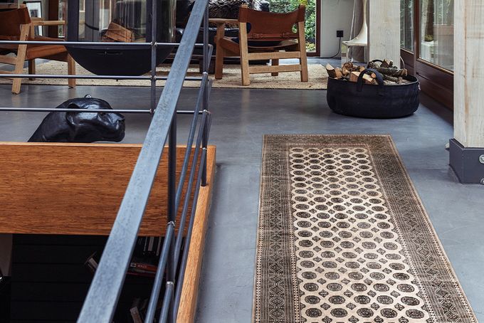 Long and narrow patterned rug on the floor of a top storey room