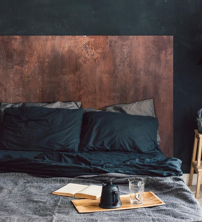 Rustic wooden detailed wall art on a bedroom wall above a king-size bed