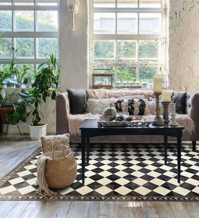 A black and white chessboard-patterned rug on a living room floor