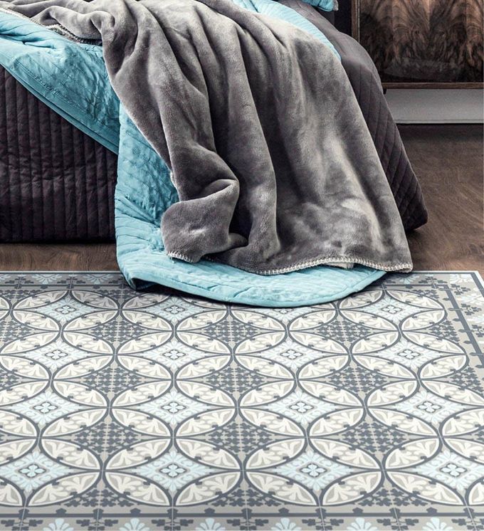 Blankets draped over intricately pastterned rug