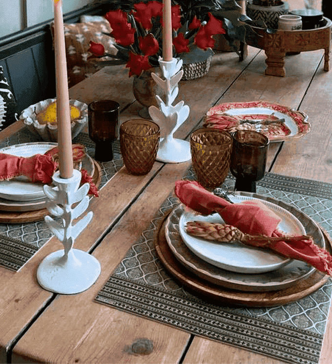 A festively decorated Christmas dinner table with red and green details