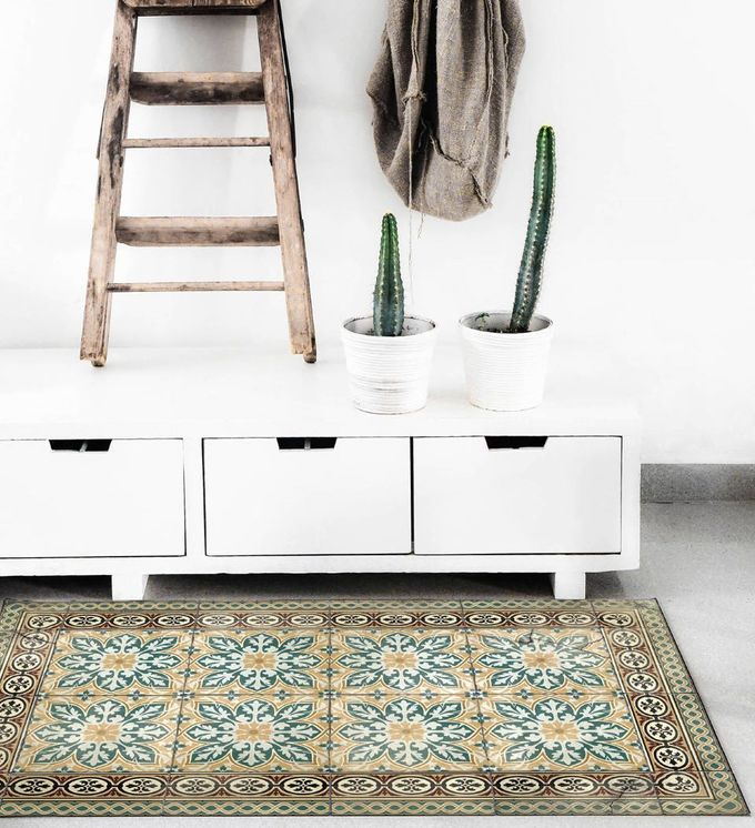 Intricately patterned rug with border in blue, yellow and brown tones