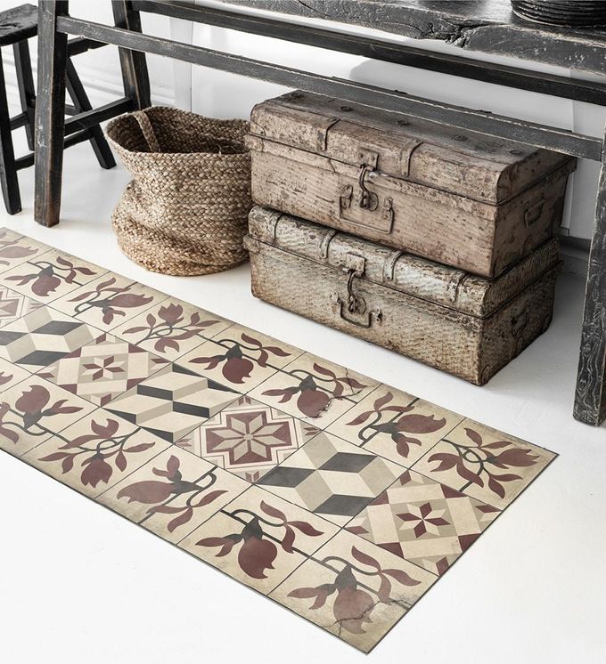 Rug consisting of floral and geometric patterned tiles in warm tones