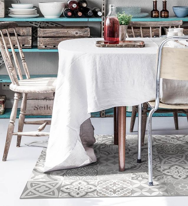 Boho-style rug with subdued tones under a dining room table