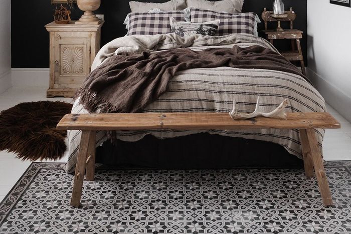 Aesthetic tile rug placed under bed with color-matching bedding