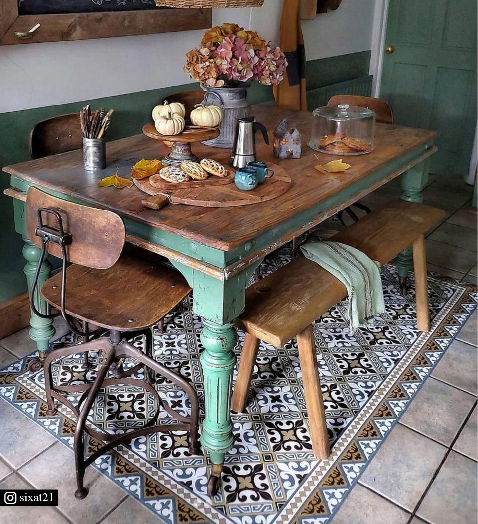 A colorful patterned rug under a vintage dining room table
