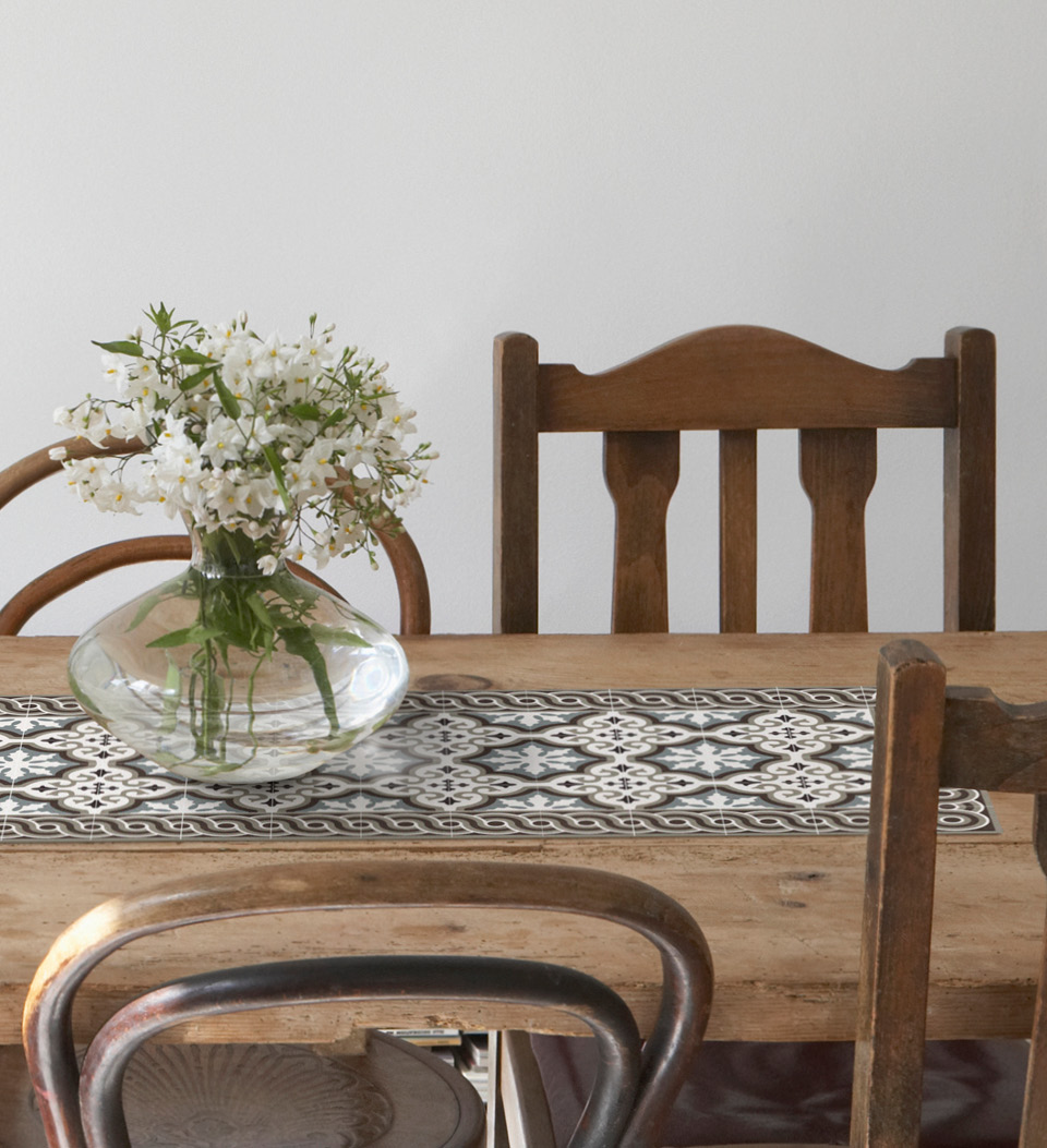 A black and white table runner with Tatami pattern on a wooden dining room table under a flower vase 