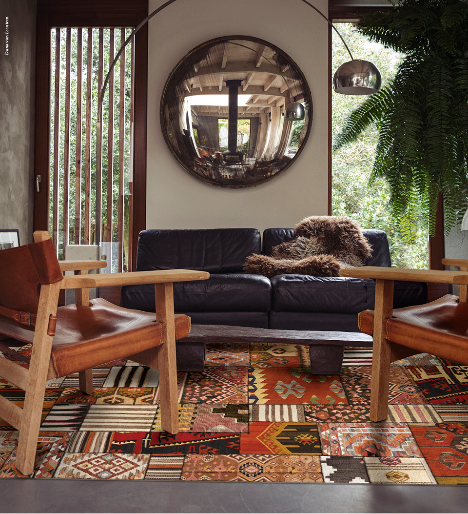 A patchwork-style colorful rug with patterns on a living room floor