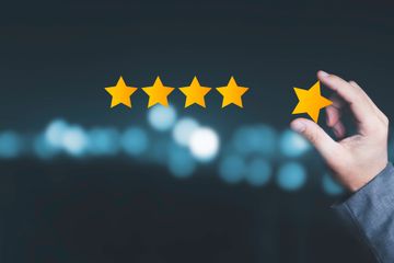 Man adding 5th gold star to 4 existing stars