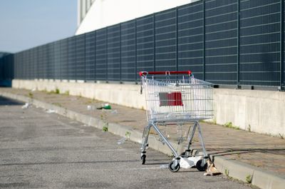 Abandoned shopping cart in empty parking lot