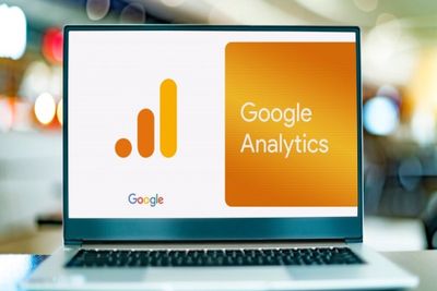 A laptop screen displaying the Google Analytics logo.