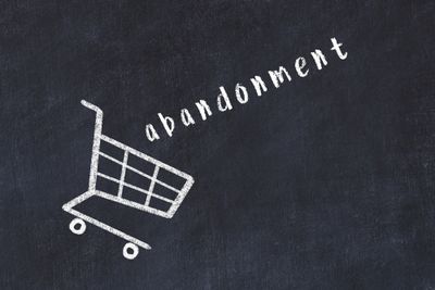 A chalk drawing showing a cart with the word abandonment in it