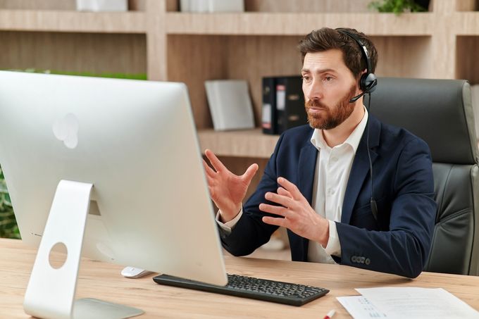 Man speaking into headset microphone in front of