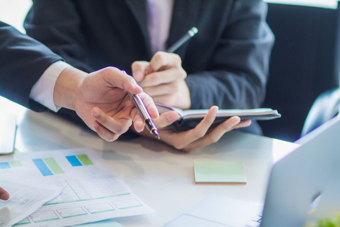 A group of business people talking about business reports