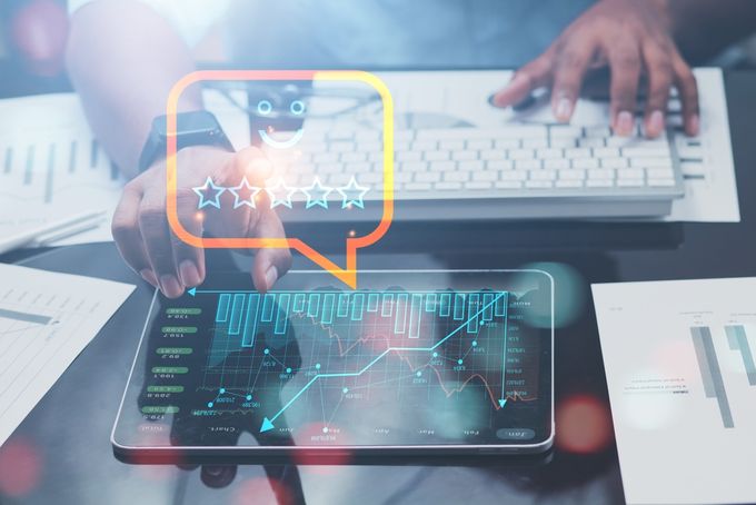 A business with his keyboard and financial graphs on a tablet