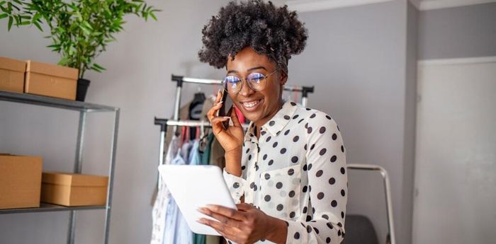 Woman holding a tablet and talking on the phone