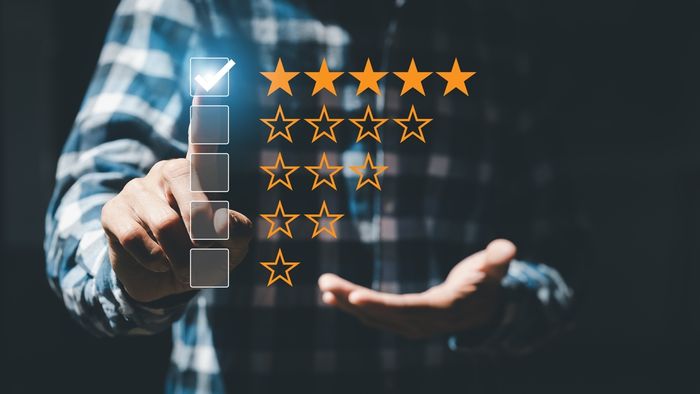 A man points at the '5 star' option on an infographic overlay of a rating system
