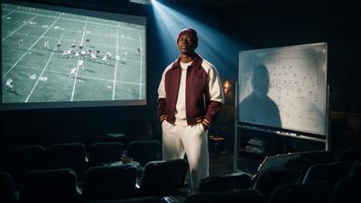 a man standing in front of a projection screen