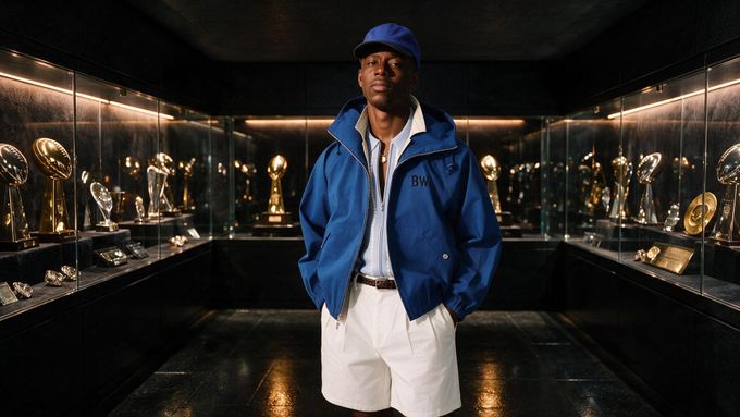 a man standing in front of a display of trophies