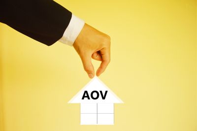 Hand in suit lifting arrow that is labelled "AOV"