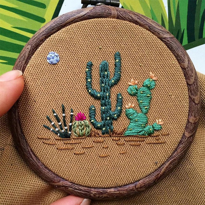 Cacti embroidered onto brown fabric