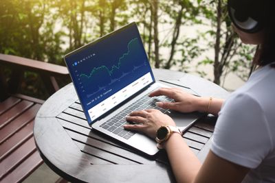 Man sitting and day trading on his laptop 