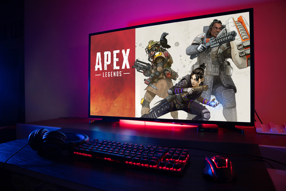 Red RGB mouse, keyboard, and TV screen showing the Apex Legends login screen