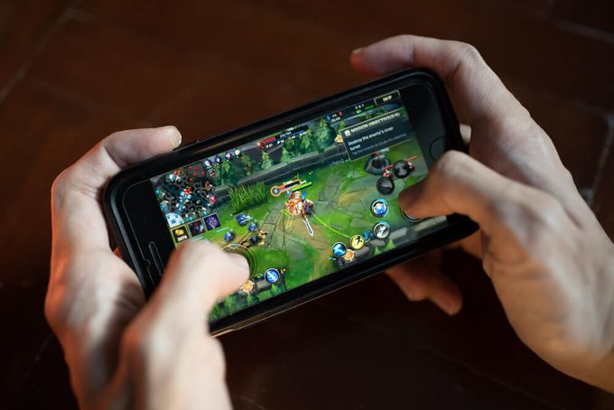 a person playing a game on a cell phone