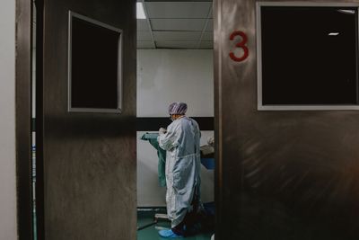 A doctor standing in a hospital hallway.