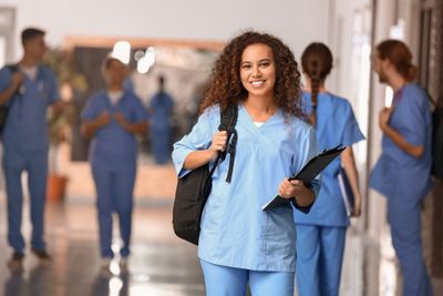 a woman in scrubs is holding a folder