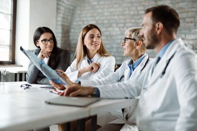 A group of doctors talking at the table.