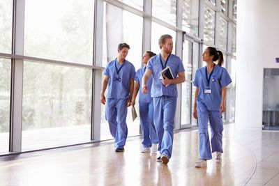 a group of doctors walking down a hallway