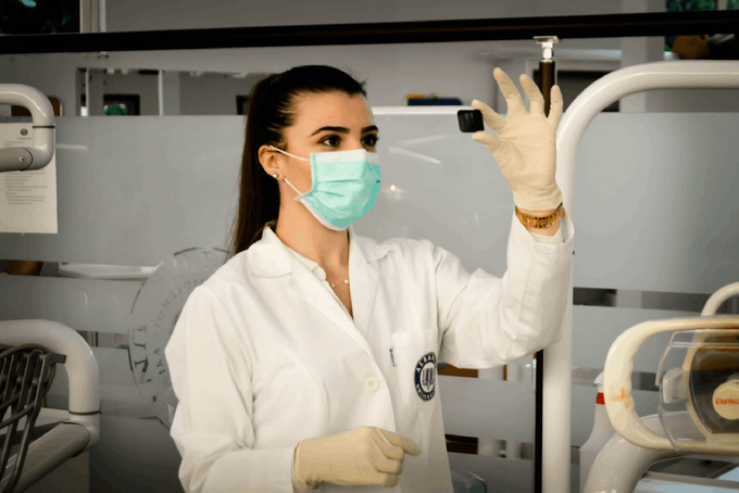 a woman wearing a face mask and gloves