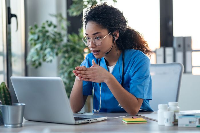 A doctor looking at a laptop.