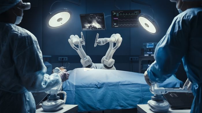 A group of doctors doing a surgery using robotic arms.