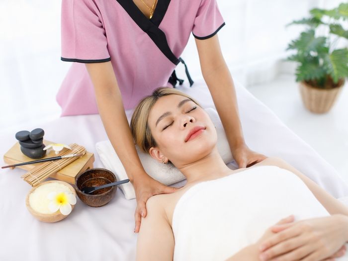 A woman getting a back massage at a spa using CBD-infused massage oil