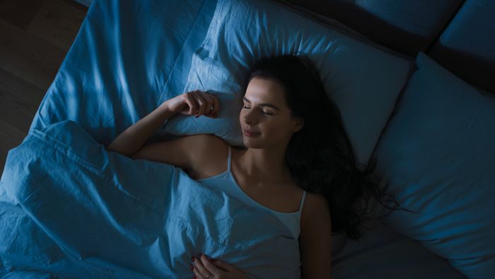 Woman sleeping peacefully in bed at night after taking Lion's Mane mushroom